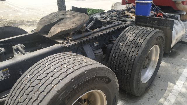 Peterbilt 386 chassis showing dual rear axles with heavy-duty tires, chassis frame, fuel tank, and fifth wheel hitch area.
