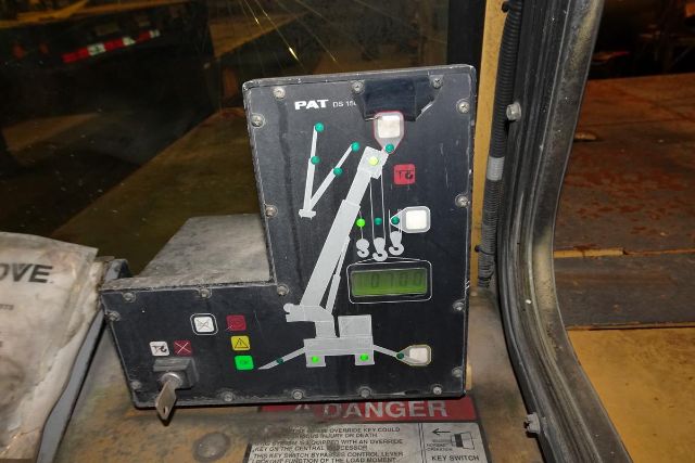Truck crane operator control panel with levers and indicator lights from a 2001 Grove YB4410, showing PAT label and numeric display.