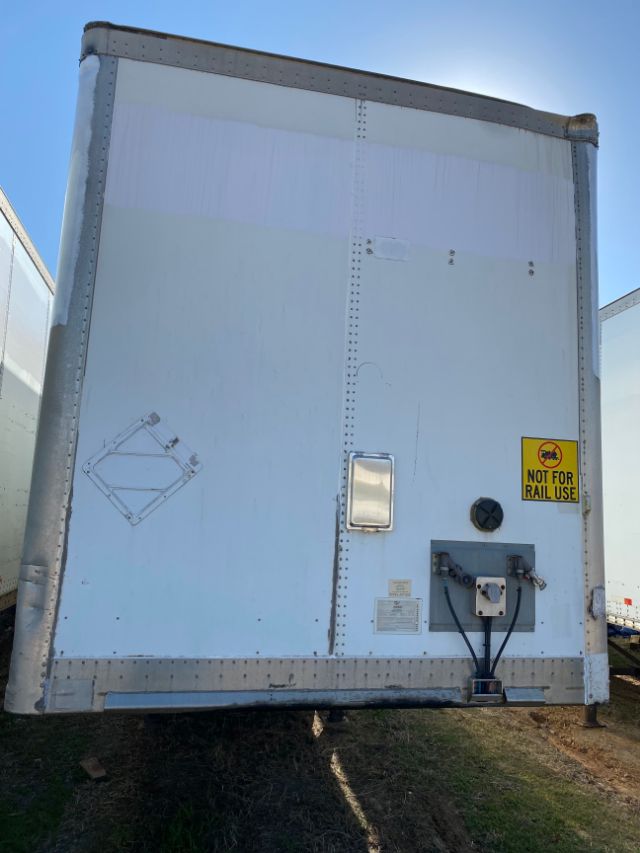 Rear view of a white box trailer with a small door, electrical plug and yellow 'Not For Rail Use' sticker.