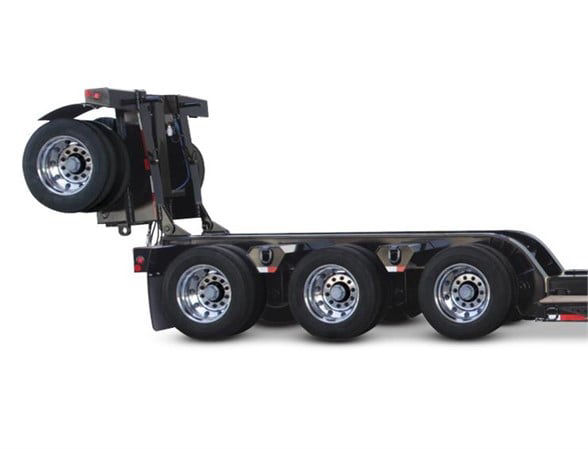  Fontaine 4th axle flip lowboy trailer with three axles visible and spare tire mounted at the front of the flip mechanism.