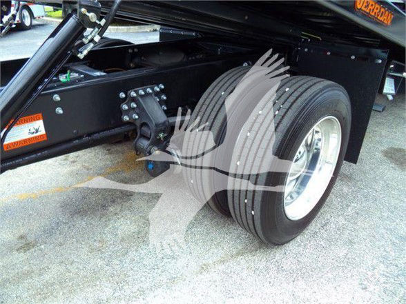 Mack MD6 truck rear dual rear wheels showing suspension and fuel tank area with warning stickers.