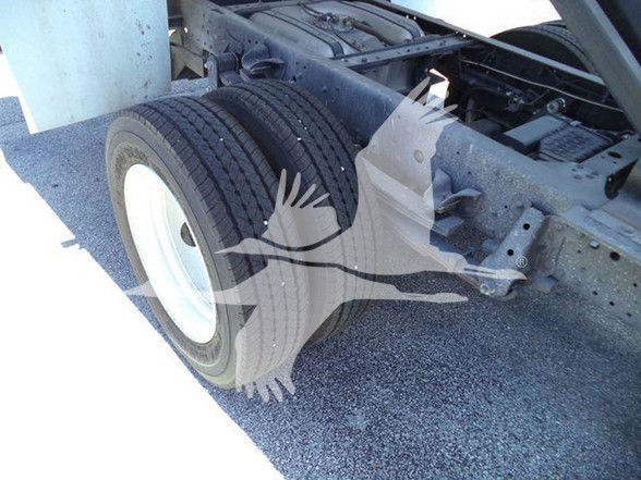 Isuzu NQR chassis showing dual rear wheels and axle suspension.