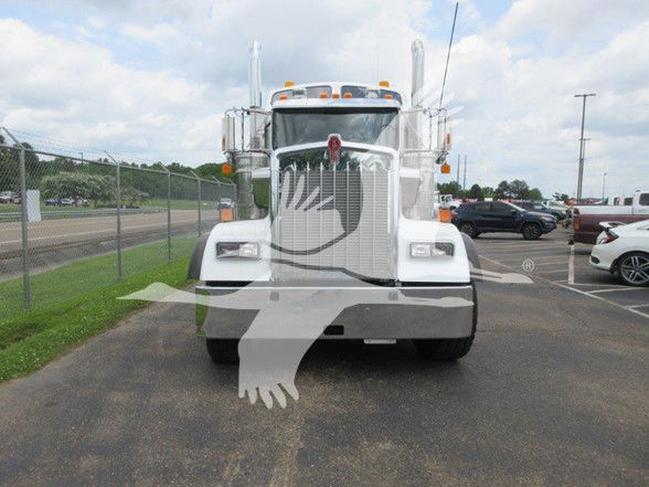 Front view of a white 2022 Kenworth W900L truck with chrome grille, vertical exhaust stacks, and large bumper. Watermark overlay covers part of the image.
