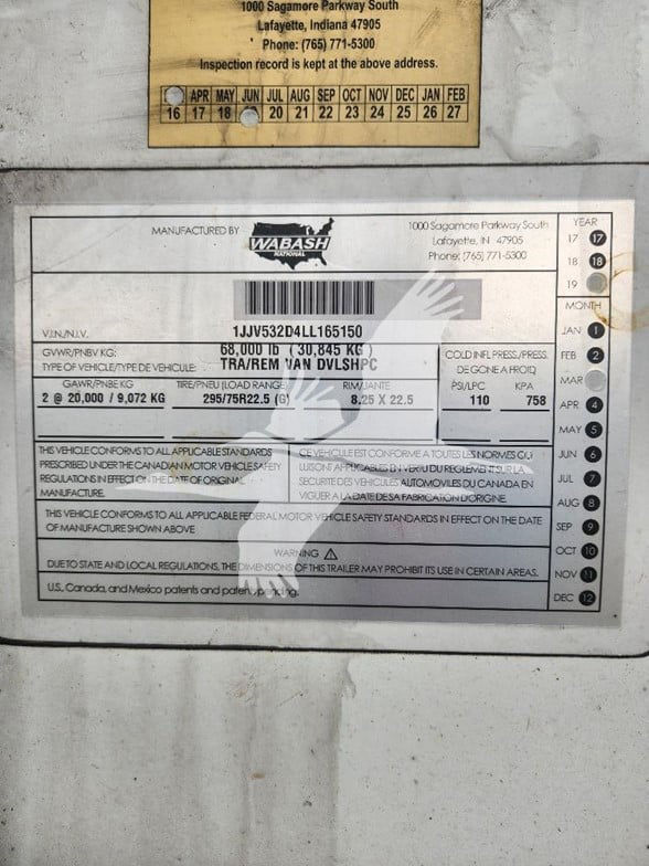 Trailer identification plate with VIN 1JJV532D4LL165150 and manufacturing label from Wabash, showing GVWR, GAWR, and tire specs.