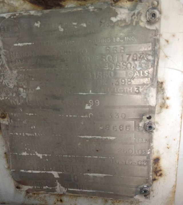 Metal identification plate on a Freightliner Cascadia with various numeric specs and labels; looks weathered but some text is visible.