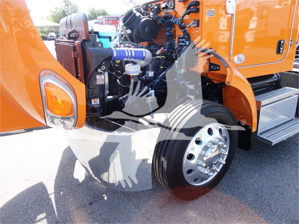 Peterbilt 337 front wheel well and engine bay area with orange body and chrome wheel, showing blue coolant hose and various engine components.