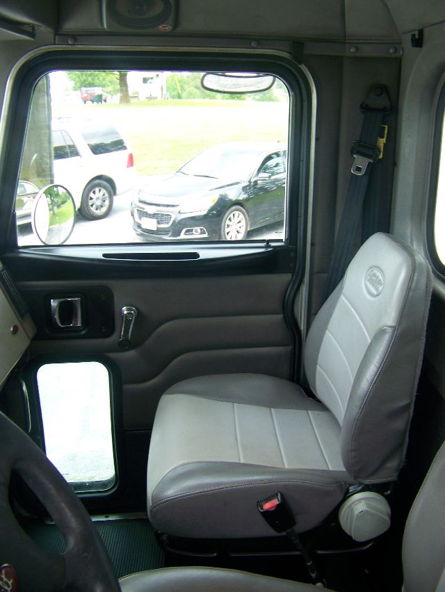 Peterbilt cab interior showing front seat and door panel from the driver’s side in a box truck.