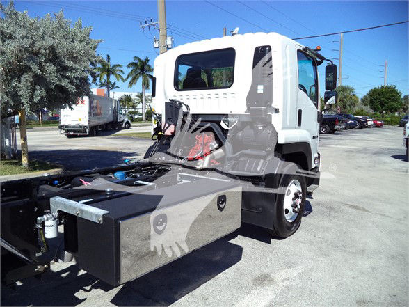 Isuzu FTR cab chassis truck with front cab and chassis, white cab, black toolbox on the frame, showing undercarriage and wiring, side view.
