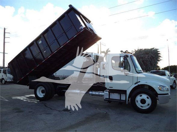 2012 Freightliner BUSINESS CLASS M2 106 dump truck side view with raised bed and hydraulic system visible.