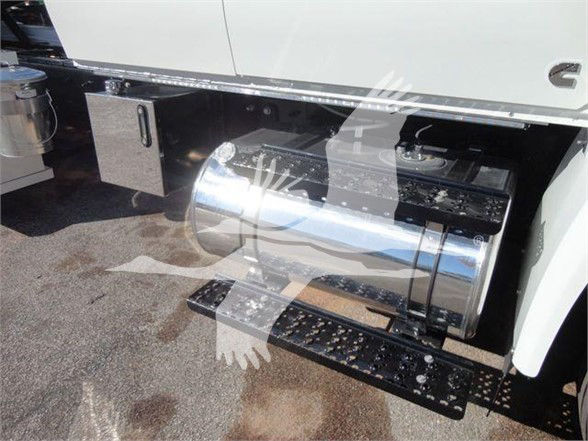 International MV truck fuel tank and side equipment showing polished cylindrical fuel tank under the cab with steps and mounting brackets.
