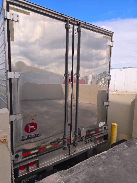 Great Dane reefer trailer rear doors showing reflective metal surface and latching hardware.