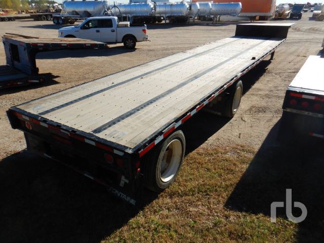 Flatbed trailer showing large aluminum deck with dual rear wheels and Fontaine branding, 40-ton Fontaine HCVTX12WSA in a used condition at a yard.