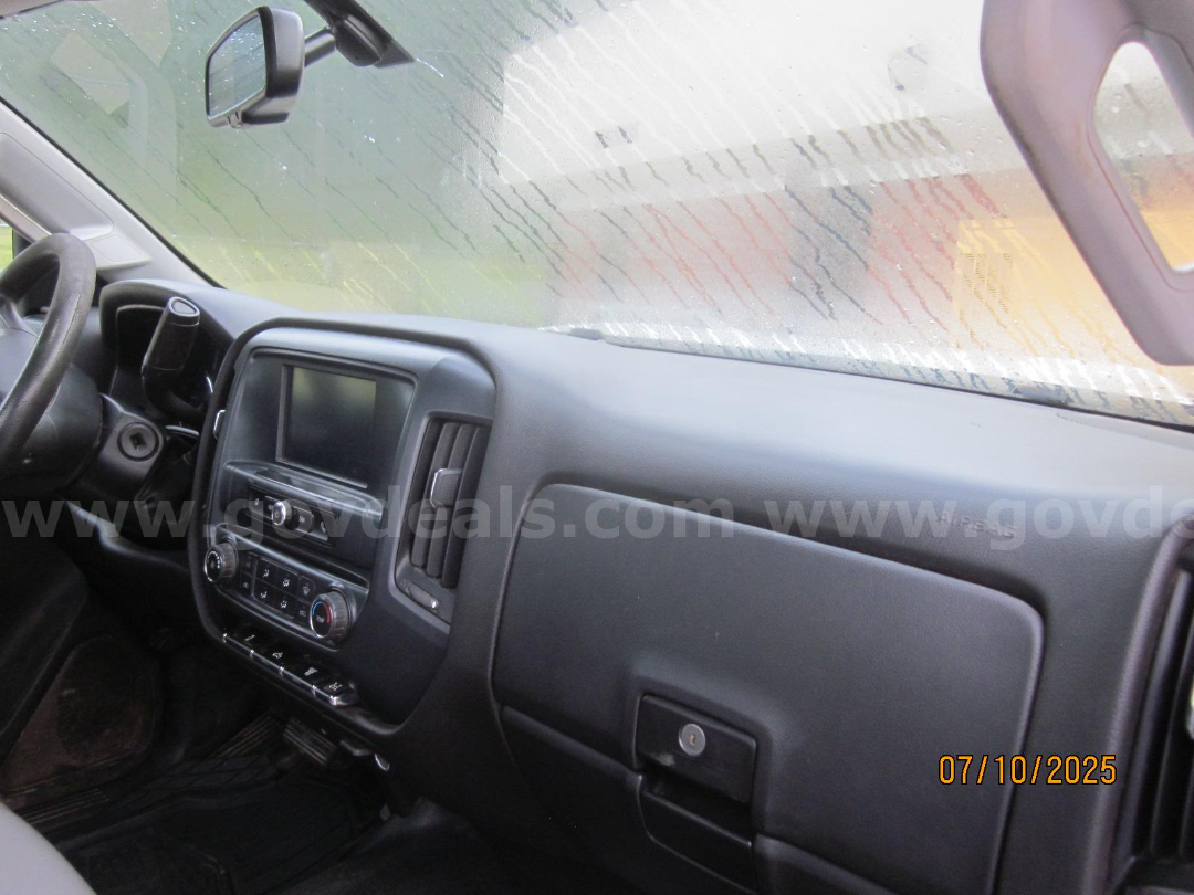 Truck interior showing dashboard with touchscreen display, climate controls, and glove compartment.