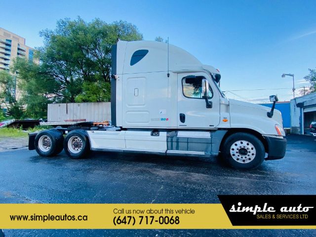 Line of 2012 Freightliner Cascadia truck tractor in serviceable condition with sleeper cab and three rear axles.
