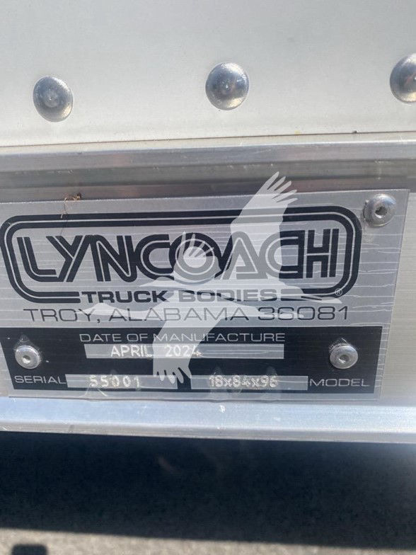 Isuzu truck rear badge plate showing Lyncoach Truck Bodies Troy, Alabama with date of manufacture April 2024 and serial/model fields.