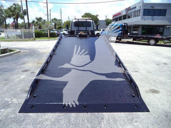 2022 International MV tow truck with a long flatbed incline showing a large bird graphic on the surface.