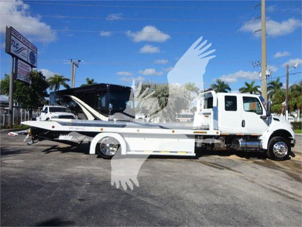 Tow truck with a car carrier bed on a white International MV chassis. Stock number STEPSIDEMV607, category Tow, type Trucks, new unit.