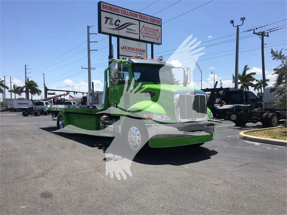 2022 Peterbilt 337 tow truck front view in bright green color.