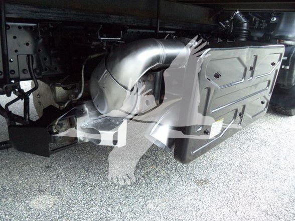 Isuzu NPR HD undercarriage showing exhaust pipe and fuel tank guard; stock number overlay partially visible.