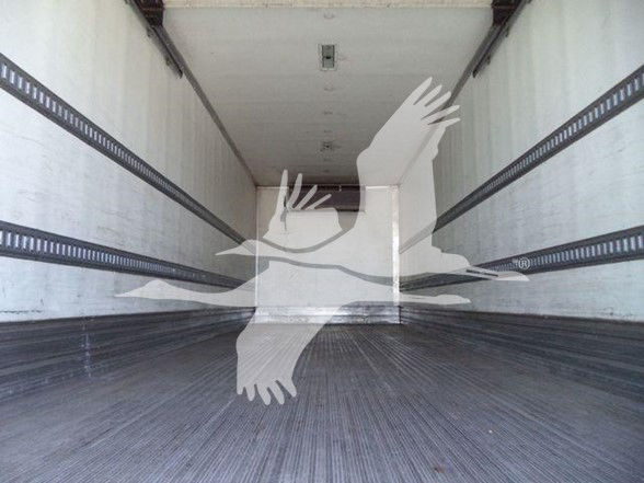 Trailer interior with empty dry cargo area seen from back toward cab; no legible labels visible.