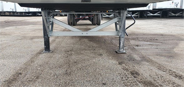 Vanguard MAXCUBE dry van trailer undercarriage showing truss-style landing gear and support frame.