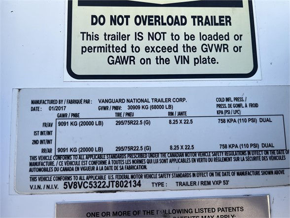 Trailer identification plate showing Do Not Overload Trailer warning and GVWR/GAWR details with VIN and model numbers.