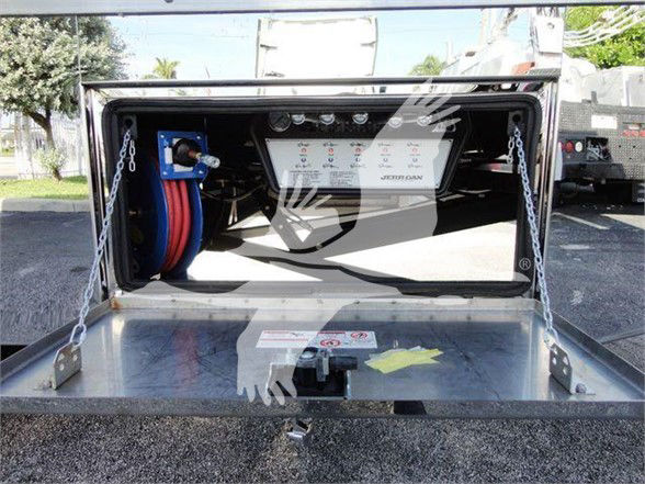 Trucks equipment bay showing control panel and hose reels inside a compartment.