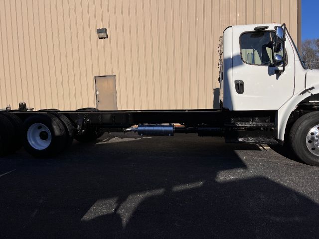 Frieghtliner M2 cab and chassis truck in side view showing chassis frame and cab, no cargo bed attached.