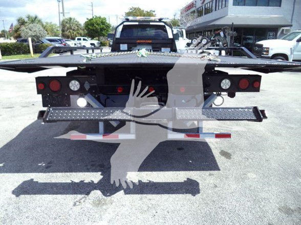 Ram 5500 tow truck chassis rear view with bumper and light bars.