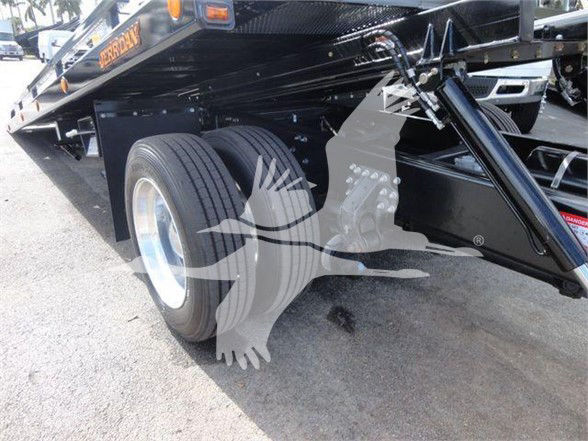 Tow truck chassis showing dual rear wheels and hydraulic system undercarriage of a 2025 Mack MD6.