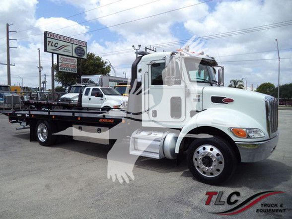 2018 Peterbilt 337 tow truck with a flatbed. Visible text includes TLC sign in background, Peterbilt branding on vehicle, and TLC Truck & Equipment watermark.