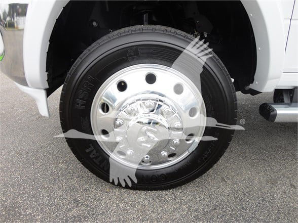 Wheel and tire on a Ram 5500 HD showing steel hubcap with lug nuts and tire tread.