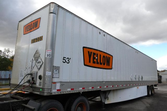 Trailer showing large orange 'YELLOW' logo on silver trailer with 53' length, parked in a lot.