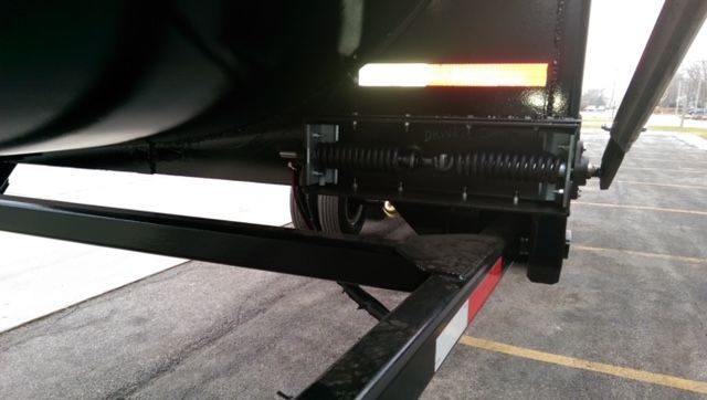 Great Dane dump trailer showing hydraulic mechanism and side rails with reflective strip near the hopper.