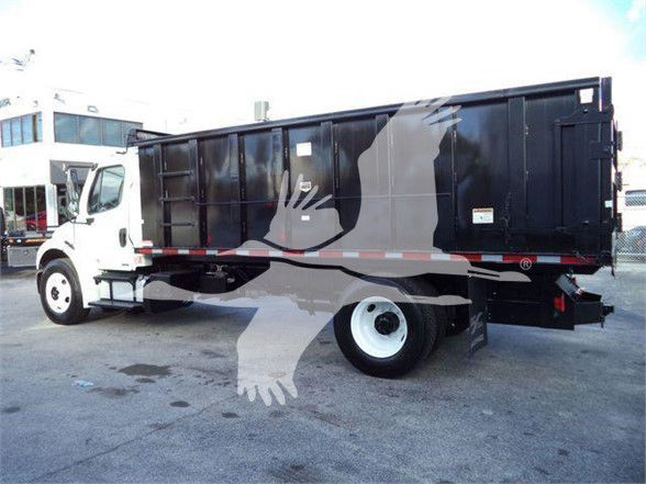 Freightliner Business Class M2 106 dump truck side view showing black dump bed and white cab with a large bird watermark across image.