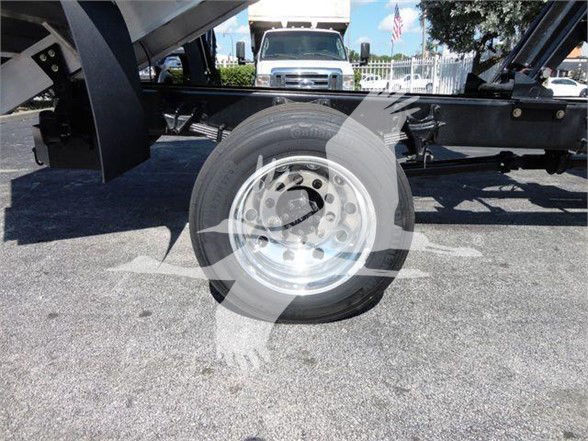 Wheel and chassis of a 2023 International MV truck chassis showing polished steel wheel and tire.