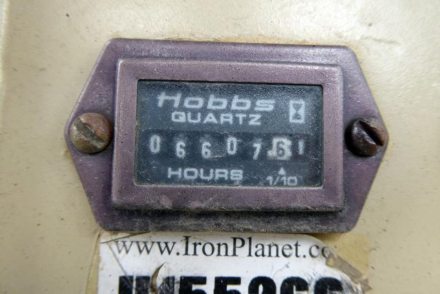 Hour meter display reading Hobbs quartz hours 660? 76? showing 0660 3? on Daniels device near www.ironPlanet.com plate