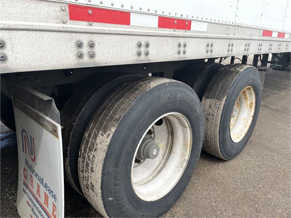 Trailer wheels and undercarriage of a used 2004 Wabash dry van trailer showing dual rear axles with tires and rims.