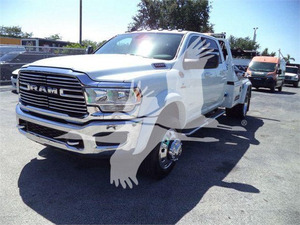 Ram 5500 truck in white with chrome grille and dual rear wheels visible, front three-quarter view.
