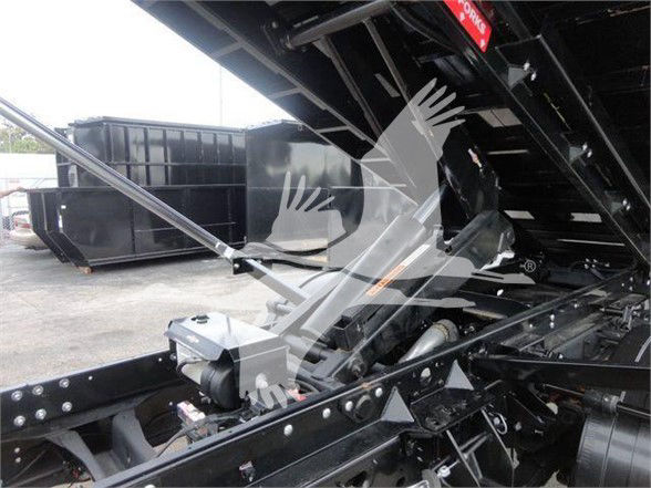 Ram 5500 SLT hooklift truck chassis showing hydraulic cylinders and frame components.
