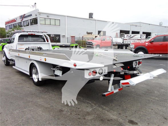 2023 Ram 5500 HD SLT tow truck with flatbed rear view showing bumper, lights, and equipment on bed.