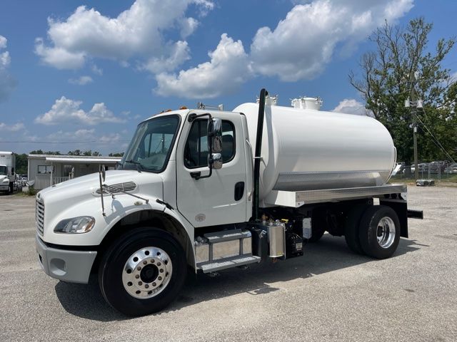 Truck showing a 2013 Freightliner M2 sewer rodder with a white cylindrical tank mounted on the chassis, front cab, side steps, and dual rear wheels.
