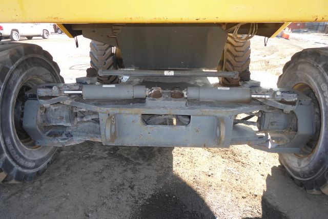 Grove T60 undercarriage showing hydraulic cylinders and axle bridged components.