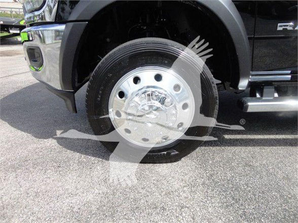 Front wheel of a 2024 Ram 4500 SLT showing a polished steel wheel and tire with a portion of the fender and step side visible.