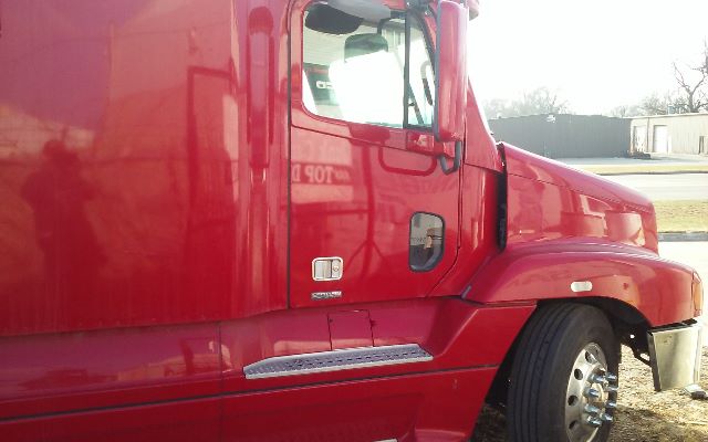 Truck cab of a red 2006 Freightliner Conventional ST120 showing front passenger door area, side step, and front fender.