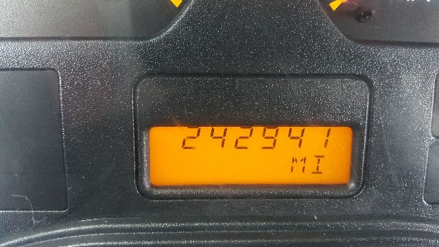 Dashboard odometer reading 242,? visible on orange LCD display of International truck gauge cluster.