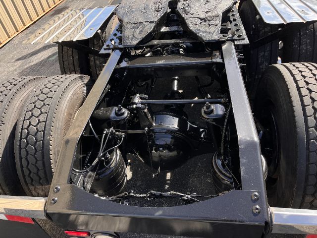 Truck rear view showing chassis, suspension, and rear axles of a 2018 Peterbilt 579 Daycab.
