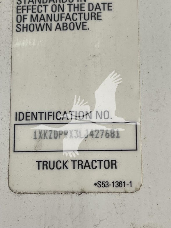 Identification plate showing VIN 1XKZDP9X3LJ427681 on a Kenworth T880 truck. Text includes IDENTIFICATION NO., TRUCK TRACTOR, and serial number area.