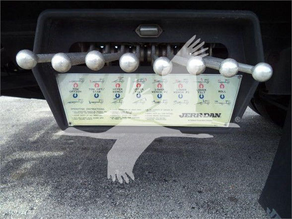 Kenworth T370 truck rear with tow hitch and control panel showing various switches and labels.