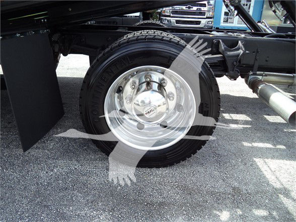 Truck wheel and suspension showing a single rear tire and chrome hub with metallic rim.